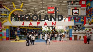 People enter the park under a large sign reading “Legoland: Japan”